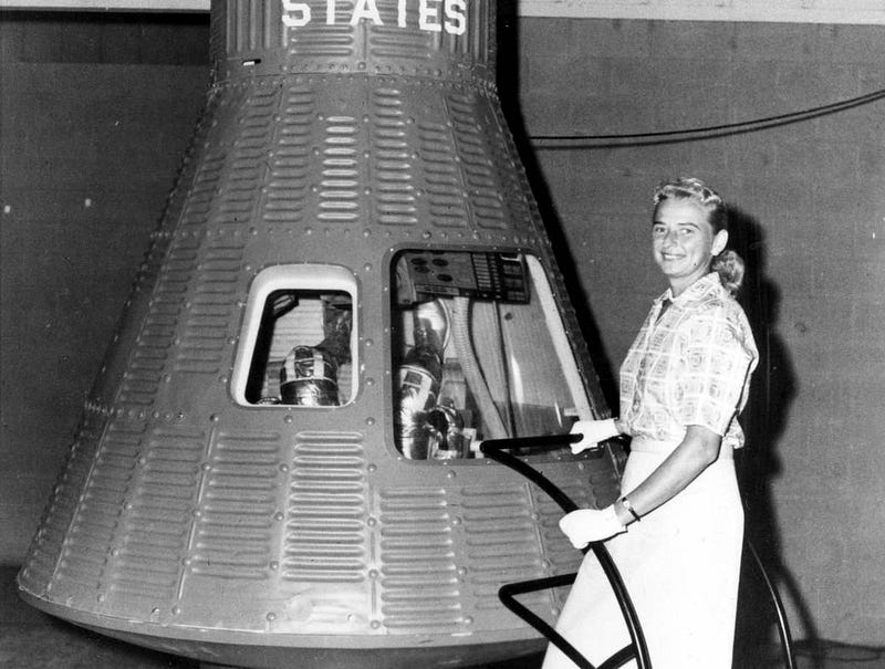 Jerrie Cobb next to a Mercury space capsule